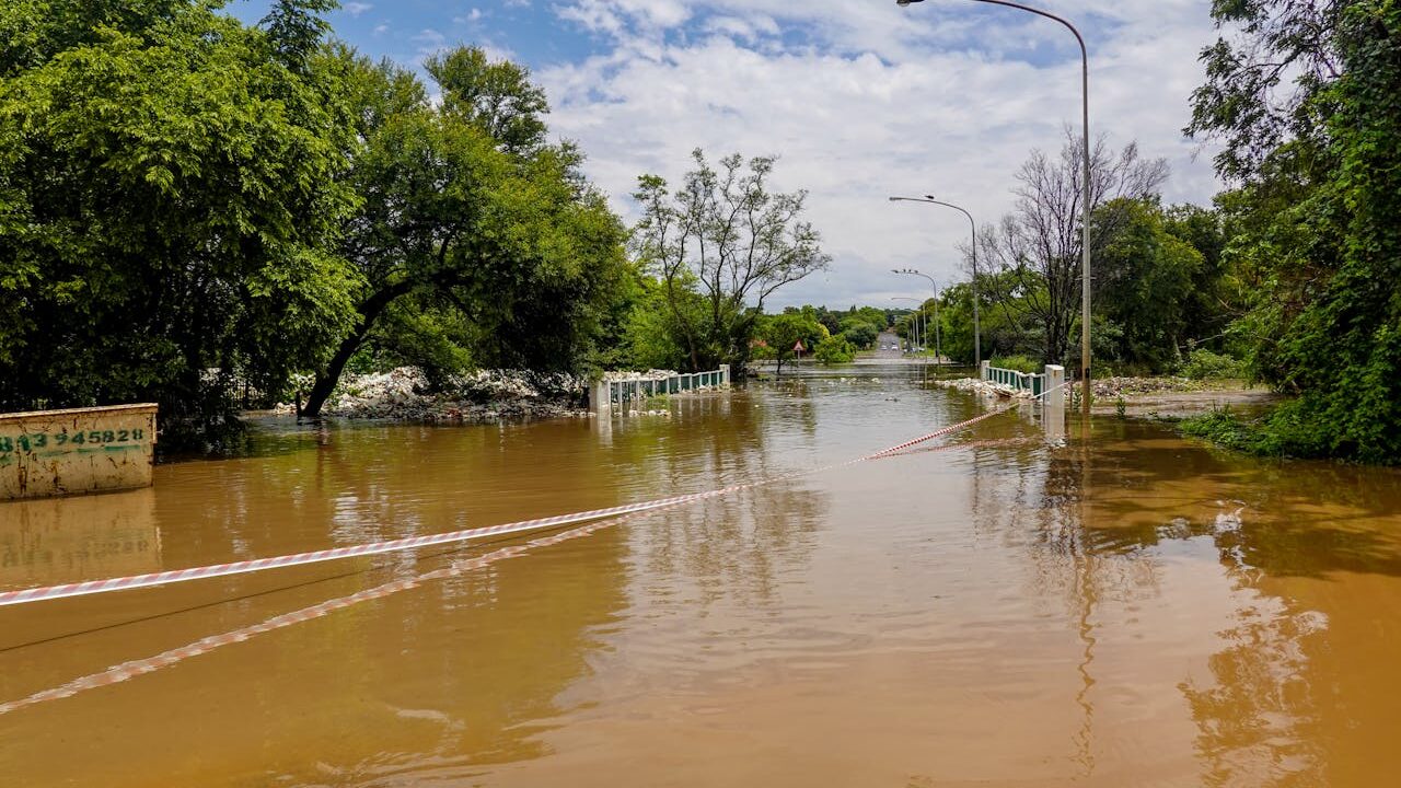 Image: A flooded street with caution tape