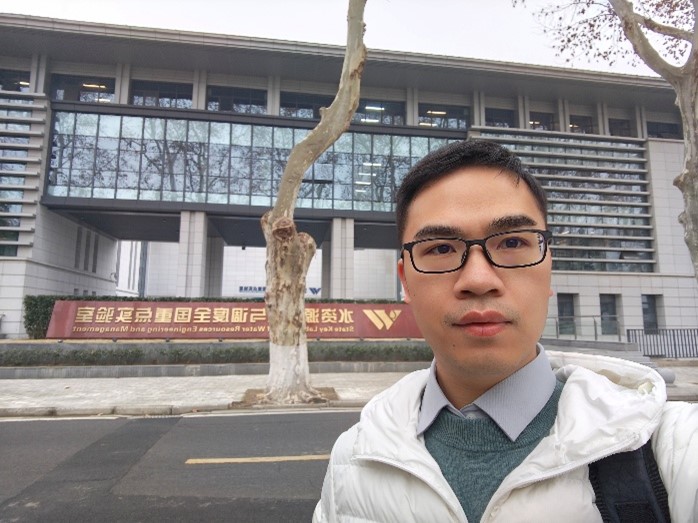 Guoqiang Tang standing in front of the State Key Laboratory of Water Resources Engineering and Management in Nanjing, China