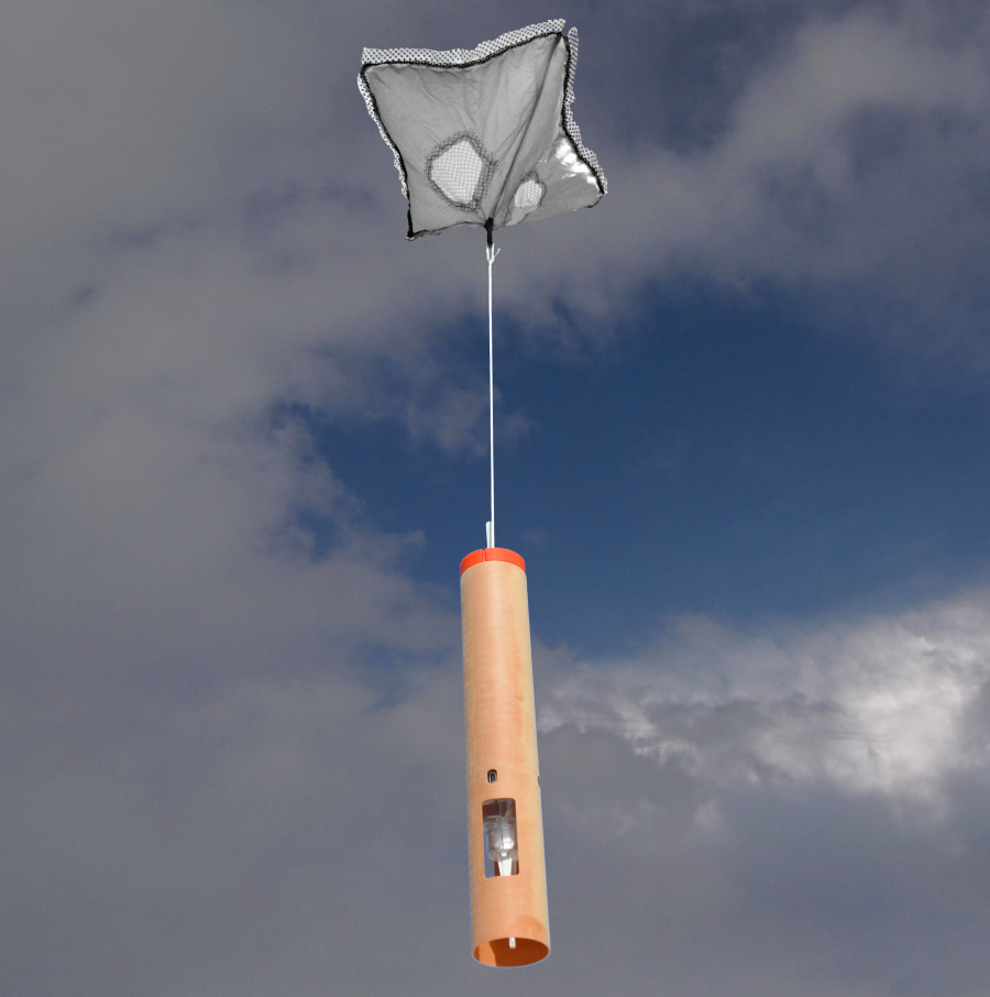 Photo of a dropsonde descending from the sky attached to a parachute