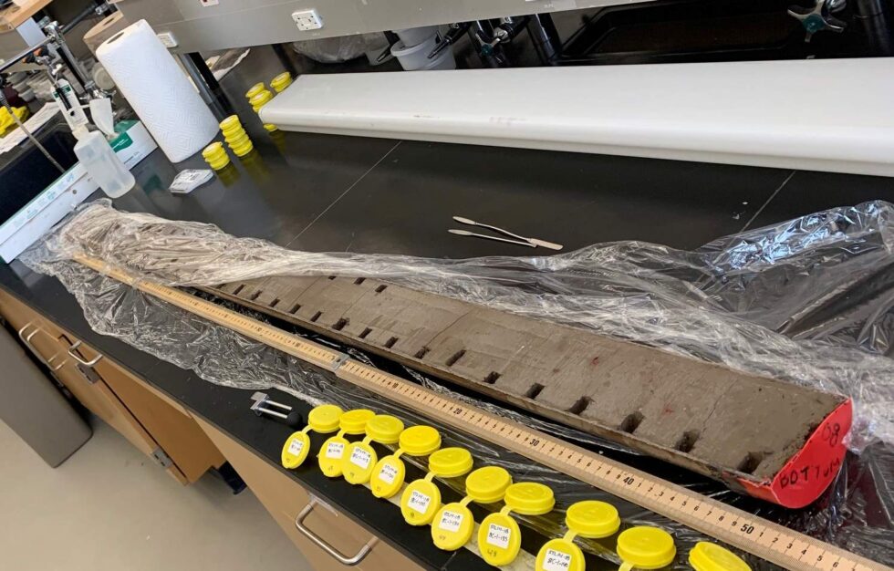 The Stoneman Lake sediment core sits on a lab table, partially unwrapped from plastic.
