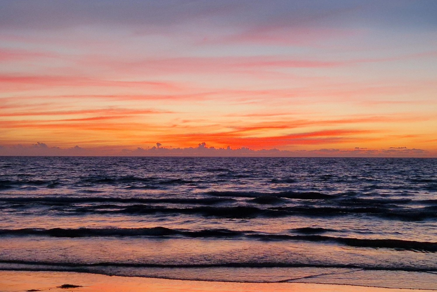 Photo of sun setting over the ocean