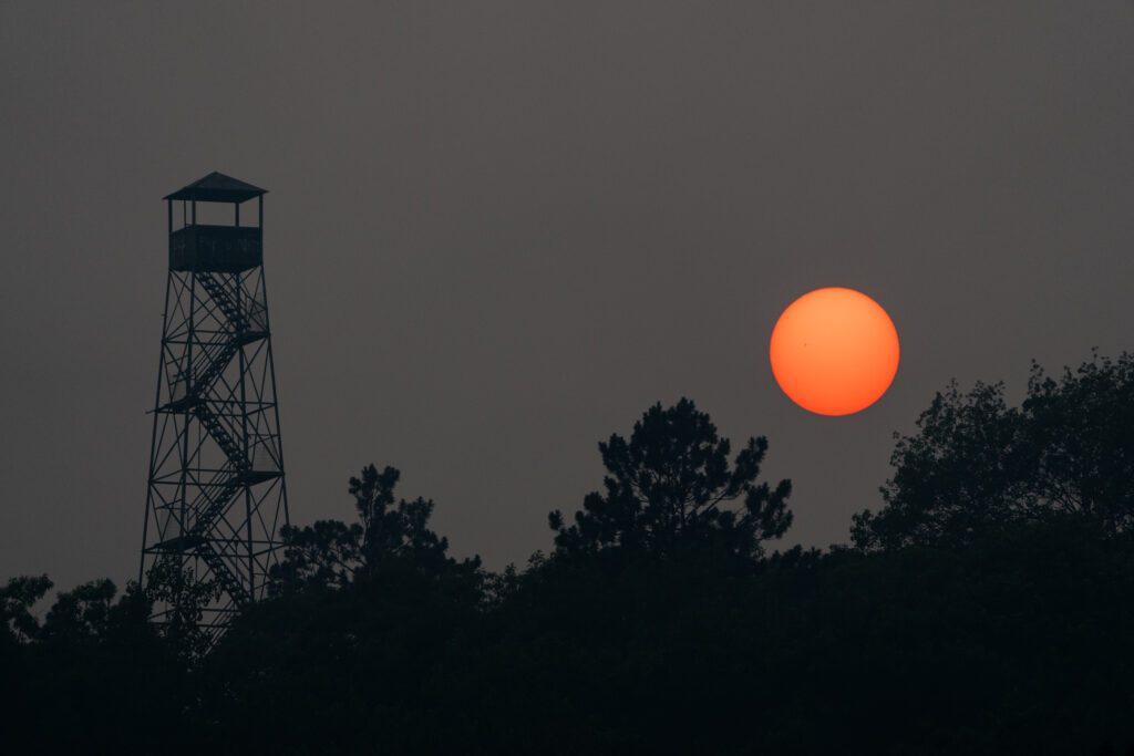 Canada Wildfire Smoke Creates a Hazy Sunset behind the Big Sandy Fire Tower in McGregor, Minnesota