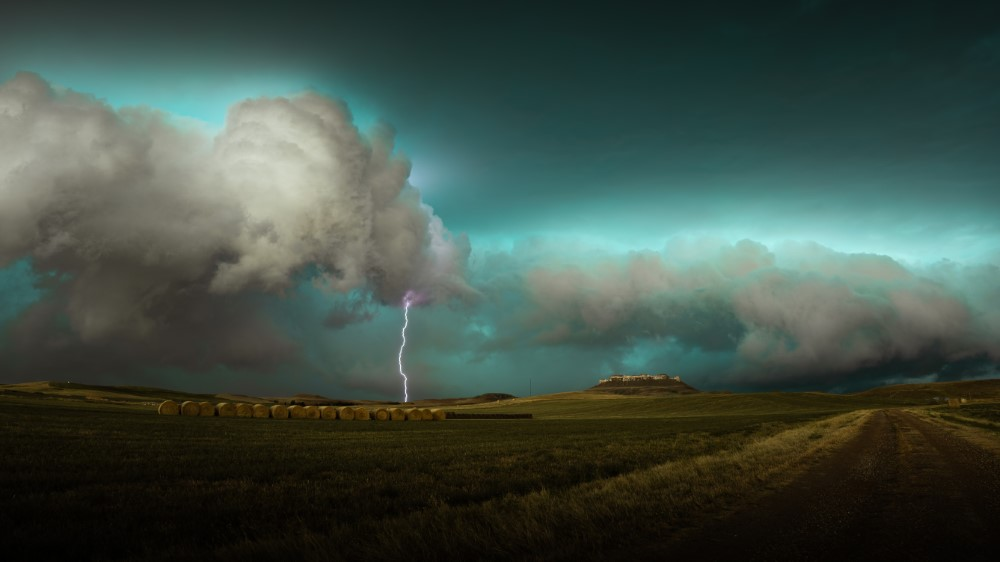 AMS 2024 Photo Contest finalist. An electric severe thunderstorm rolling over the beautiful prairie and bluffs of Western South Dakota.