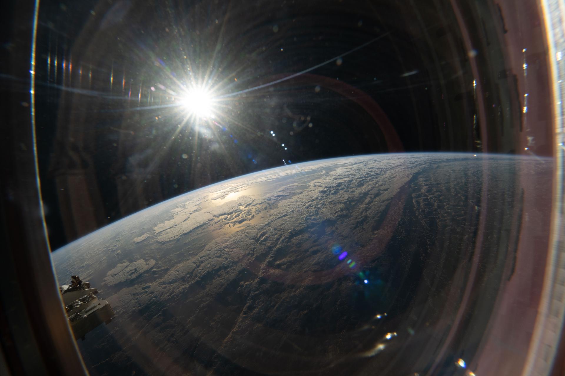 (Sept. 9, 2026) This view from a window on the SpaceX Dragon highlights the sun illuminating a cloudy Pacific Ocean as the International Space Station orbited 263 miles above Earth. NASA ID: iss075e0103110