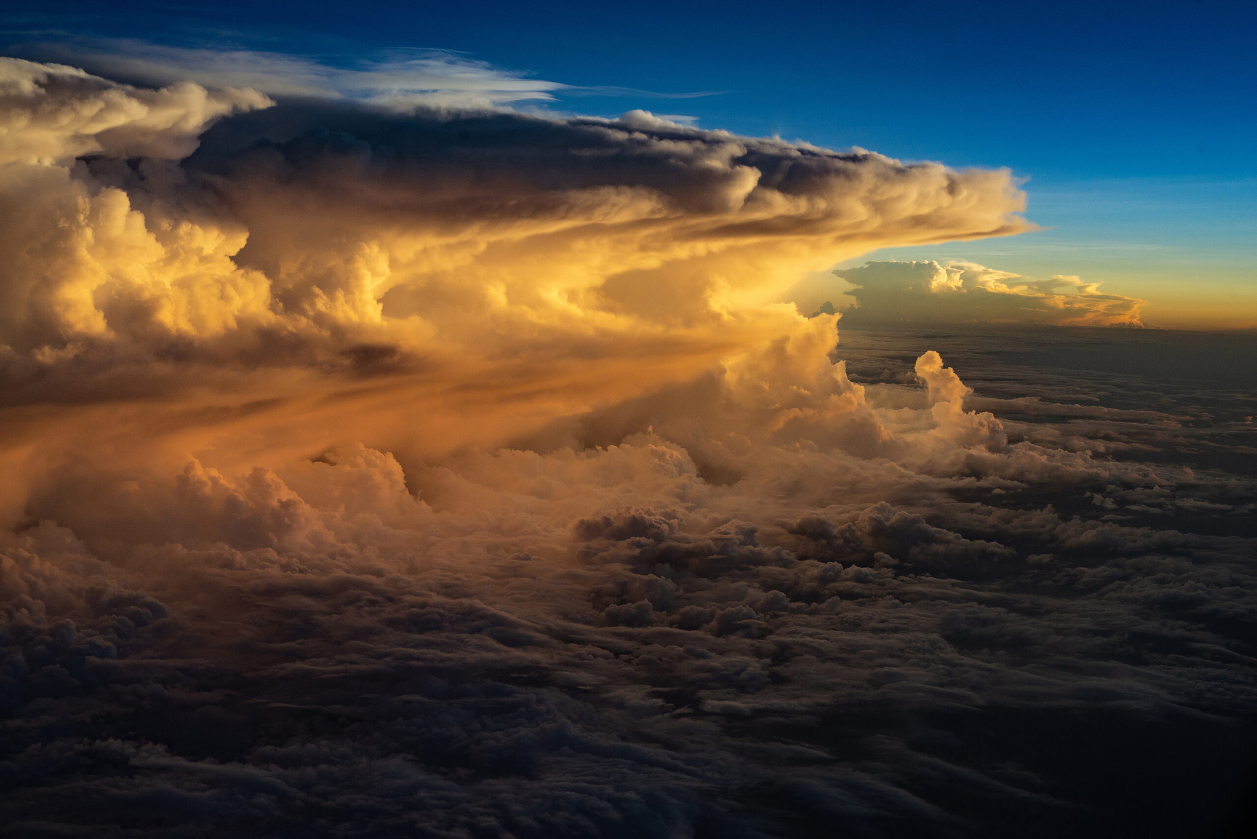 A cumulus of clouds can be seen from 10,000 feet above sea level from an airplane, while they are illuminated by the last rays of the sun at some point in the Yucatan Peninsula, in southern Mexico.