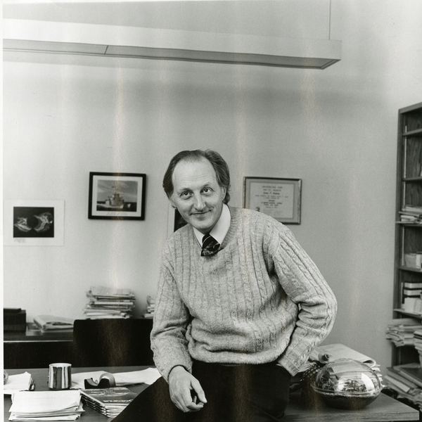 Francis Bretherton sitting on a desk in an office